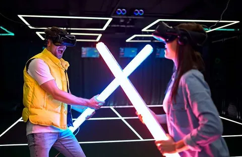 Handsome man and beautiful young woman experiencing games using different VR