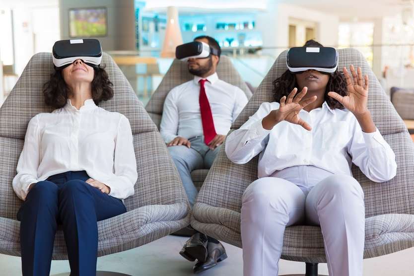 Diverse team of colleagues experiencing difference VR sets