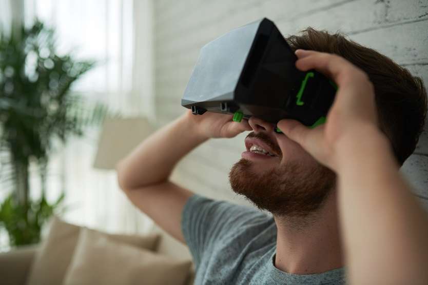  Young man wearing latest virtual reality device